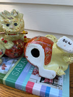 Underside and condition detail of ceramic foo dog pair