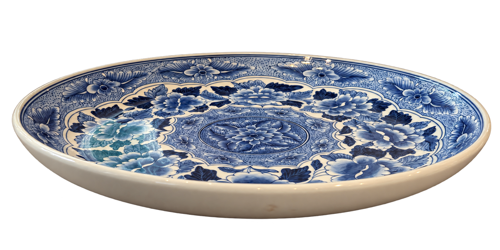 Side view of blue and white floral charger plate showing raised rim