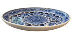 Side view of blue and white floral charger plate showing raised rim