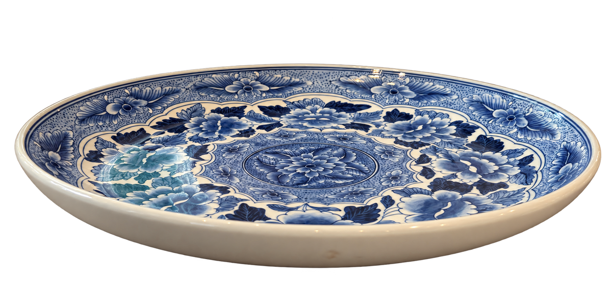 Side view of blue and white floral charger plate showing raised rim