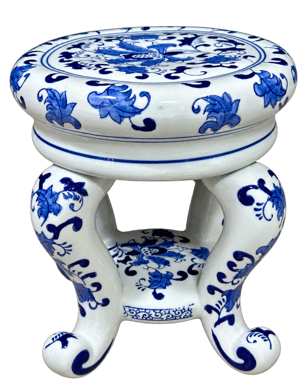 Blue and white floral ceramic stand with scroll feet, angled view
