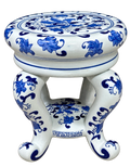 Blue and white floral ceramic stand with scroll feet, angled view