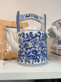 Blue-and-white floral ceramic teapot with tall arched handle