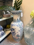 Tall chinoiserie floor vase decorated with peacocks, butterflies, bamboo, and flowers in blue, green, and blush tones.