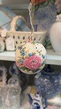 Porcelain potpourri ball with pink and blue flowers, green leaves, and a gold hanging cord