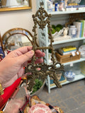 Ornate gold-tone tabletop easel with scrolling foliage and floral details
