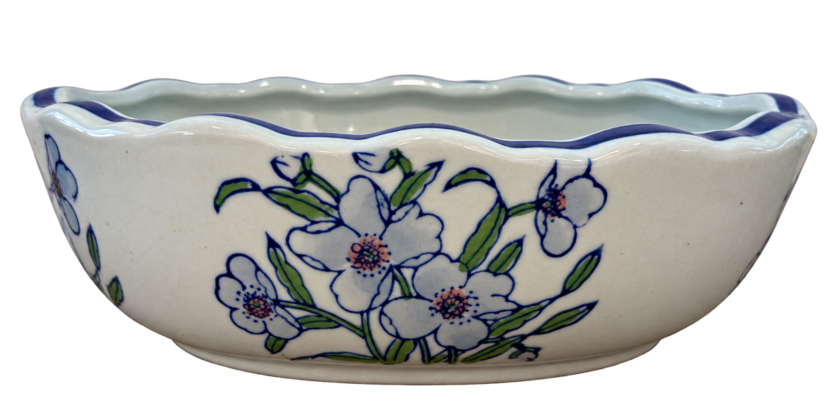 Oval porcelain bowl with blue scalloped rim, green leaves and floral decoration