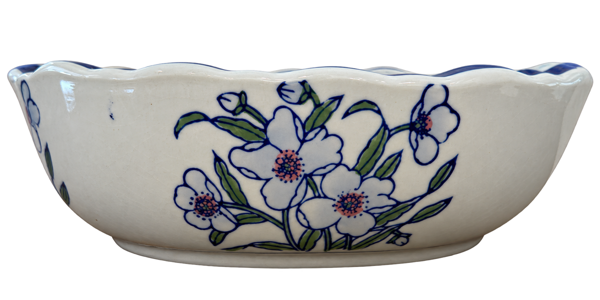 Oval porcelain bowl with blue scalloped rim, green leaves and floral decoration