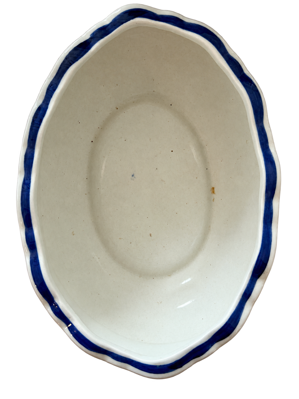 Oval floral bowl interior showing spotting and glaze wear