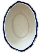 Oval floral bowl interior showing spotting and glaze wear