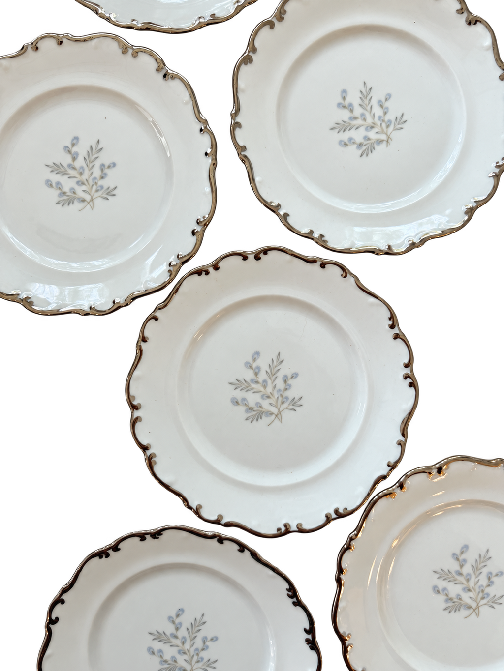 Close-up of scalloped platinum trim and blue-gray floral centers