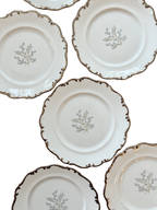 Close-up of scalloped platinum trim and blue-gray floral centers