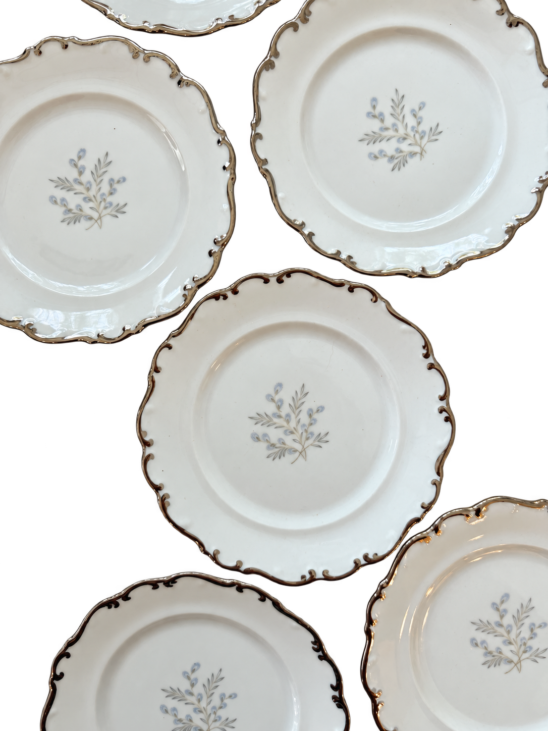 Close-up of scalloped platinum trim and blue-gray floral centers