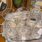 Set of four crystal martini glasses displayed on a silver tray