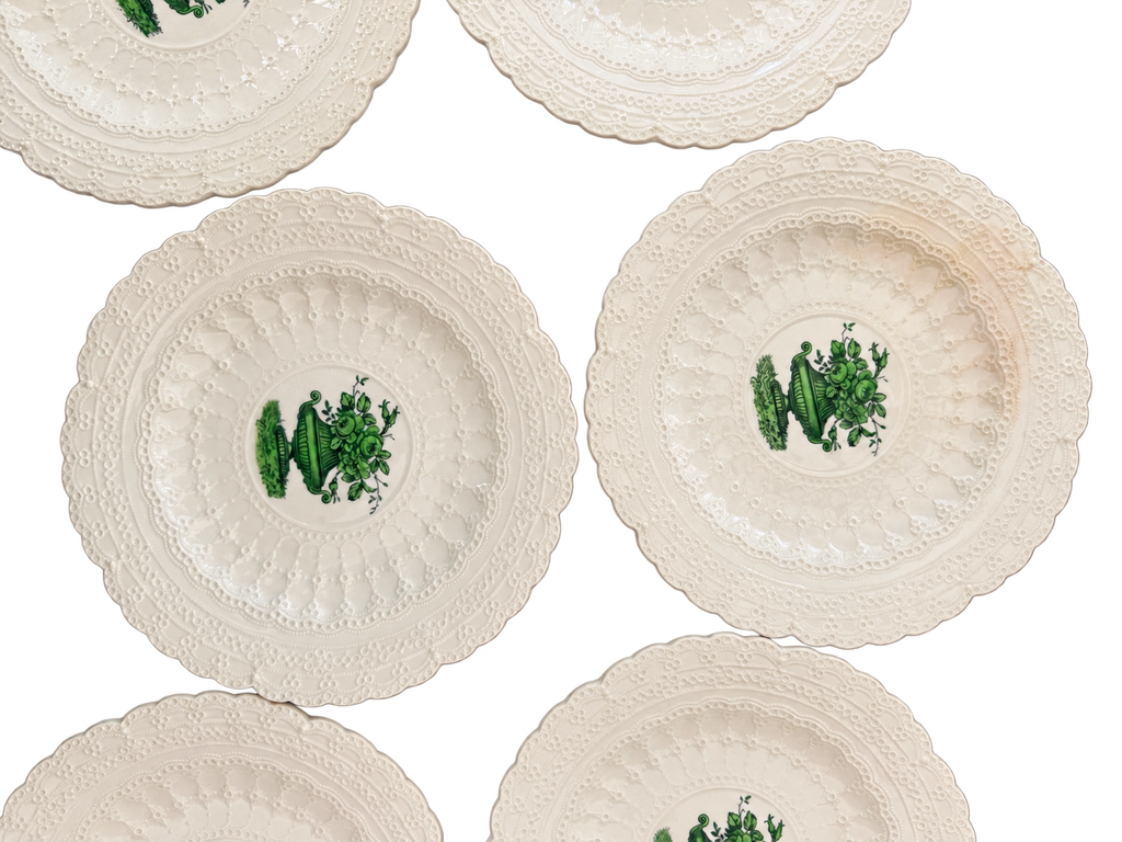 Close-up of green urn design and raised lace borders