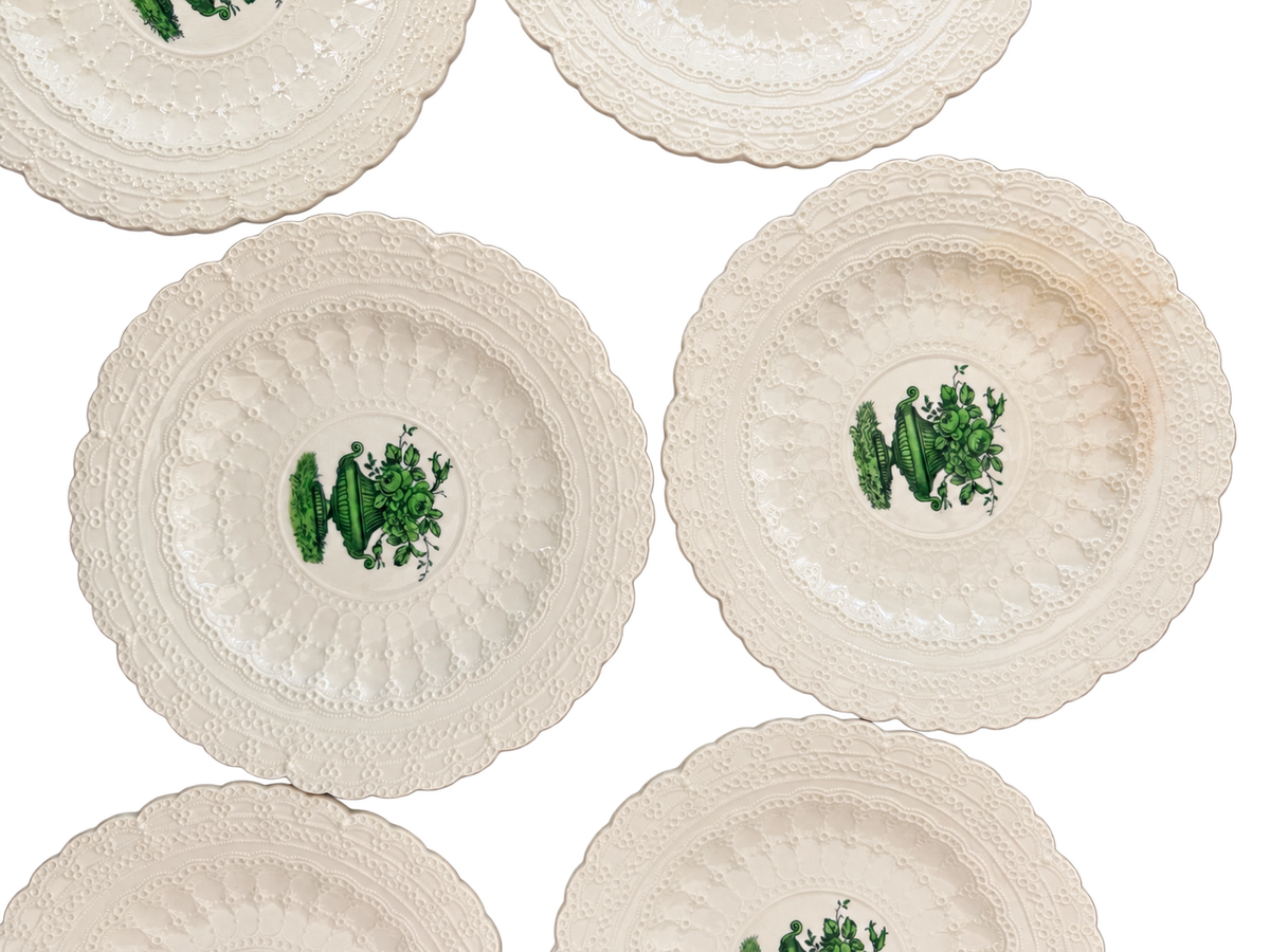 Close-up of green urn design and raised lace borders