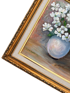 Close-up of Lucille Merrill signature, pale blue vase, white flowers, cream liner, and ornate gold frame