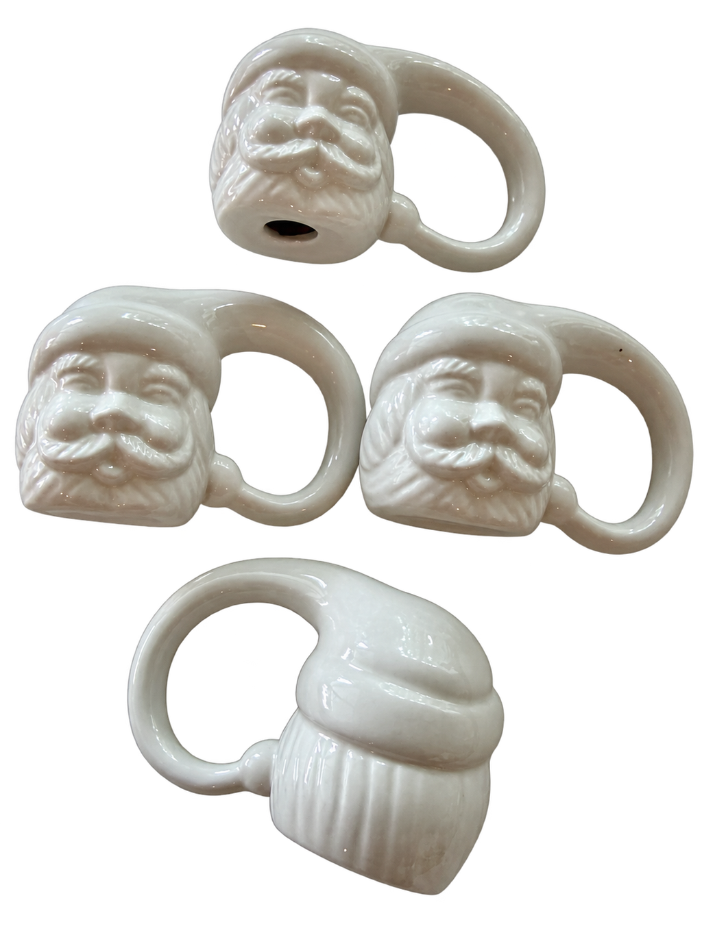 White Santa ceramic napkin rings showing sculpted faces and reverse