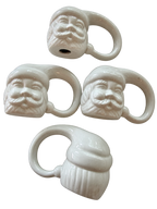 White Santa ceramic napkin rings showing sculpted faces and reverse