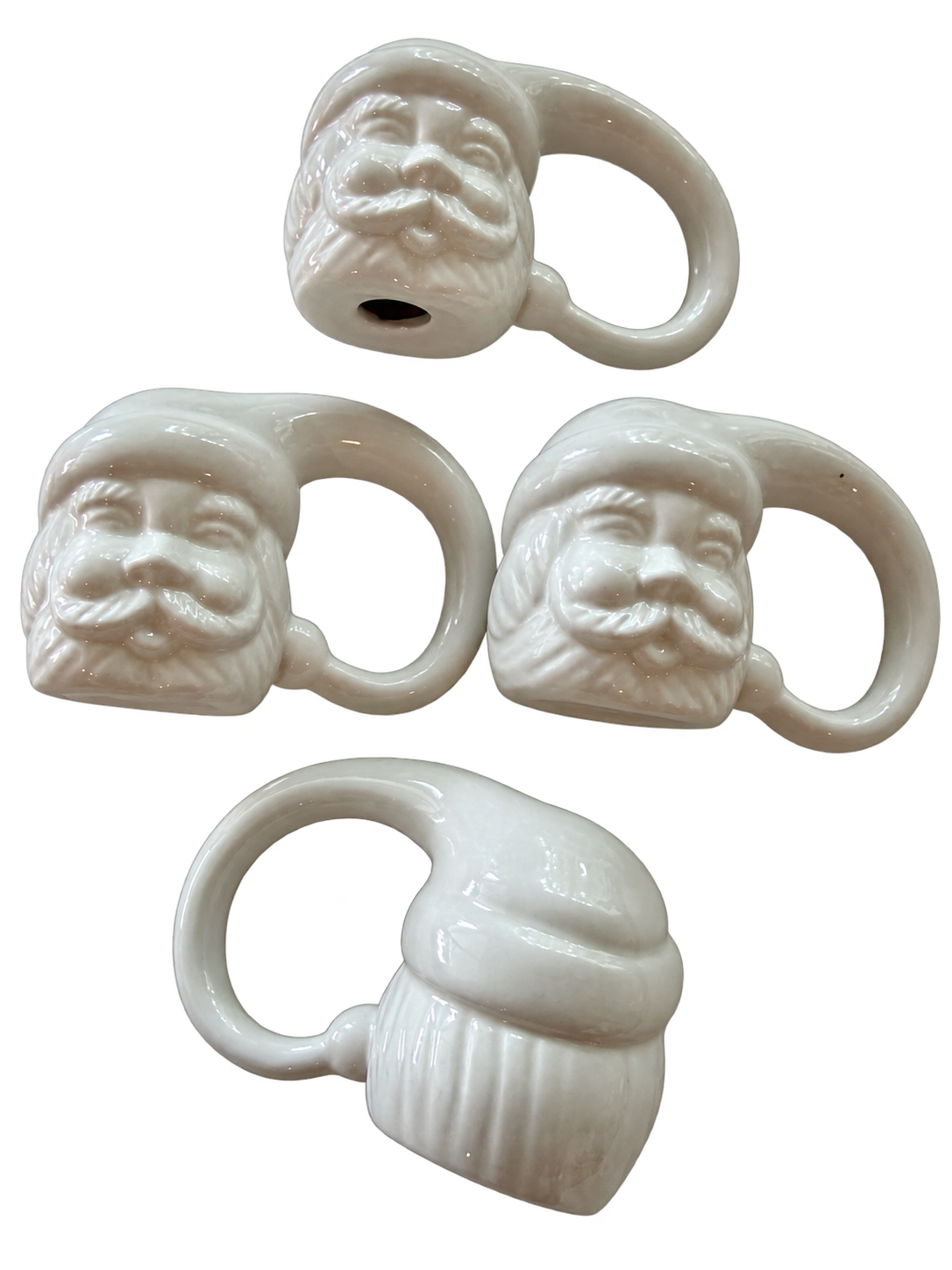 White Santa ceramic napkin rings showing sculpted faces and reverse