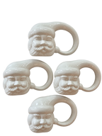 Set of four white ceramic Santa Claus napkin rings