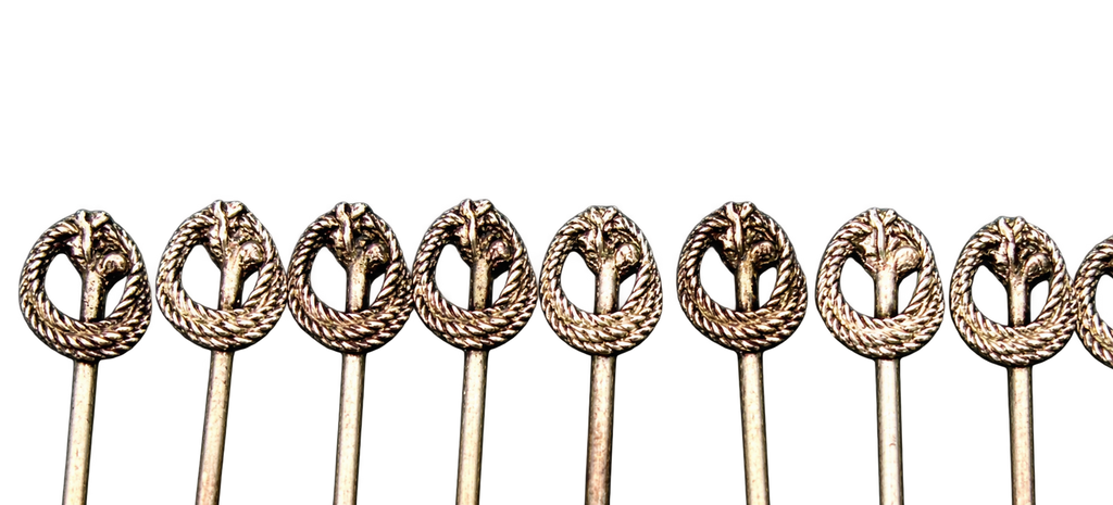 Close-up of wreath and botanical finials on the cocktail picks