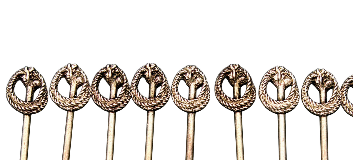 Close-up of wreath and botanical finials on the cocktail picks