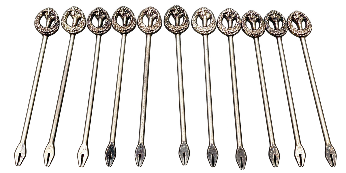 Eleven silver-tone cocktail picks with wreath and botanical finials